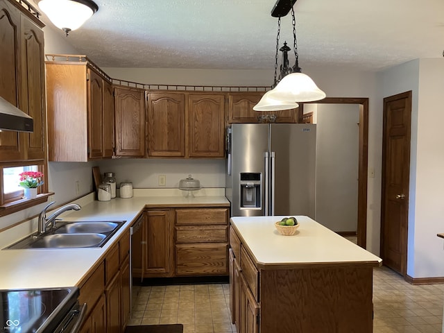 19938 State Road 37 N, Noblesville, IN 46060 - kitchen featuring appliances with stainless steel finishes, light countertops, decorative light fixtures, a center island, and a textured ceiling