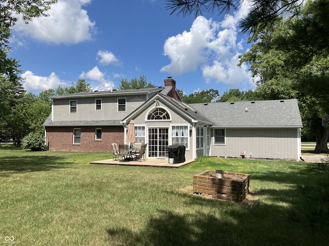 19938 State Road 37 N, Noblesville, IN 46060 - back of house featuring a chimney, a lawn, and a patio