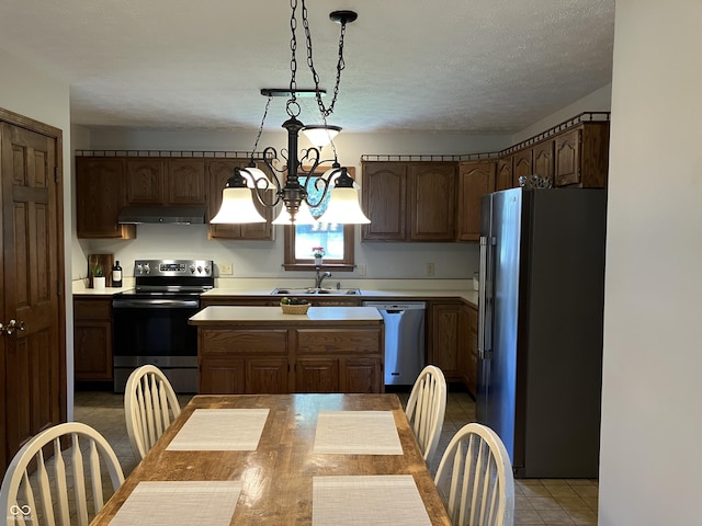 19938 State Road 37 N, Noblesville, IN 46060 - kitchen with appliances with stainless steel finishes, under cabinet range hood, light countertops, light tile patterned floors, and a textured ceiling