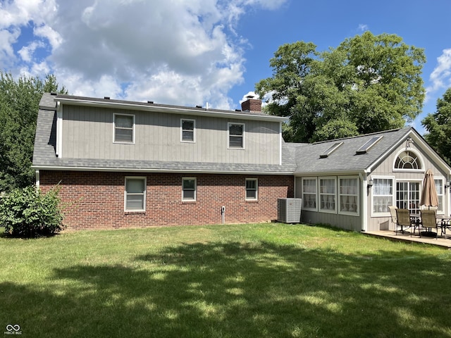 19938 State Road 37 N, Noblesville, IN 46060 - rear view of house featuring a lawn, a chimney, brick siding, and a patio