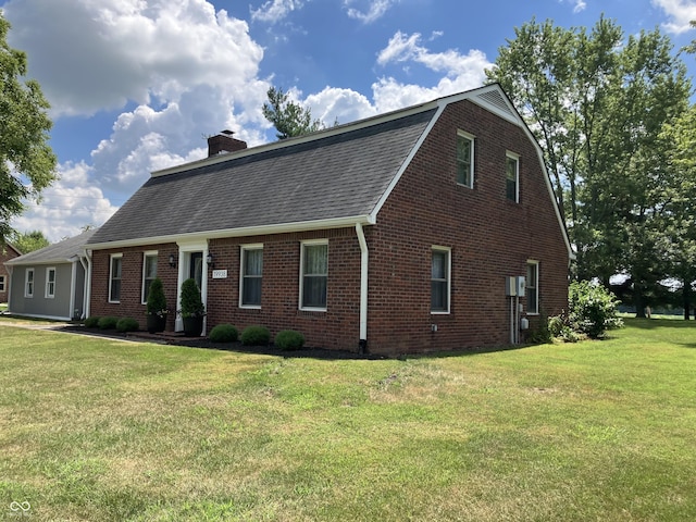 19938 State Road 37 N, Noblesville, IN 46060 - view of front of home featuring brick siding, a front lawn, a chimney, a shingled roof, and a gambrel roof