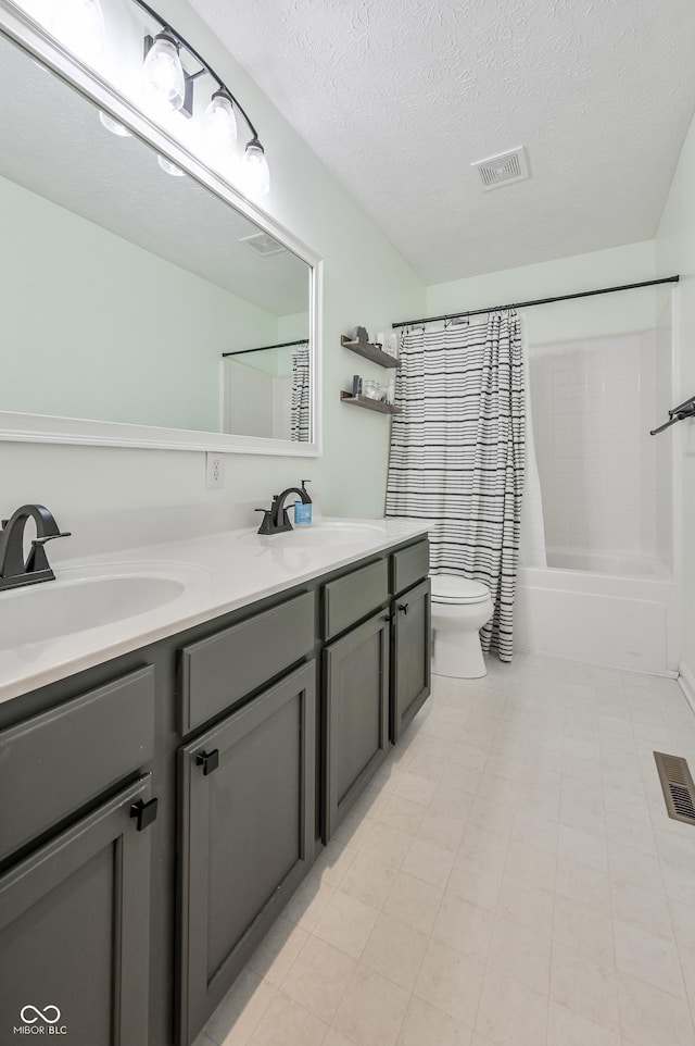7611 Prairie Fire Ct, Brownsburg, IN 46112 - full bathroom featuring double vanity, shower / bath combo with shower curtain, and a textured ceiling
