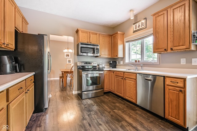 7611 Prairie Fire Ct, Brownsburg, IN 46112 - kitchen featuring appliances with stainless steel finishes, dark wood-style floors, light countertops, and a chandelier