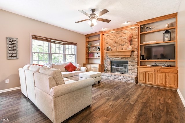 7611 Prairie Fire Ct, Brownsburg, IN 46112 - living area featuring a ceiling fan, built in features, dark wood-style floors, and a fireplace