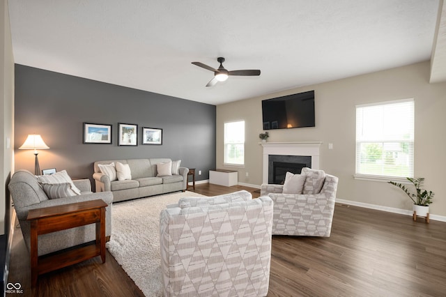12888 Girvan Way, Fishers, IN 46037 - living area featuring a fireplace, ceiling fan, and dark wood-style flooring
