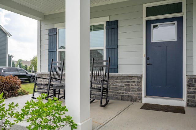 12888 Girvan Way, Fishers, IN 46037 - view of exterior entry featuring a porch and stone siding