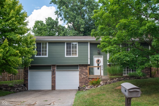 6118 Thrushwood Cir, Indianapolis, IN 46250 - bi-level home featuring an attached garage, brick siding, and concrete driveway