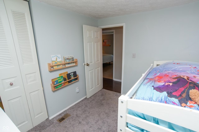 6118 Thrushwood Cir, Indianapolis, IN 46250 - bedroom with carpet, a closet, and a textured ceiling