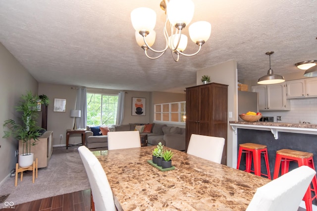 6118 Thrushwood Cir, Indianapolis, IN 46250 - dining room featuring dark wood-style flooring, a chandelier, and a textured ceiling