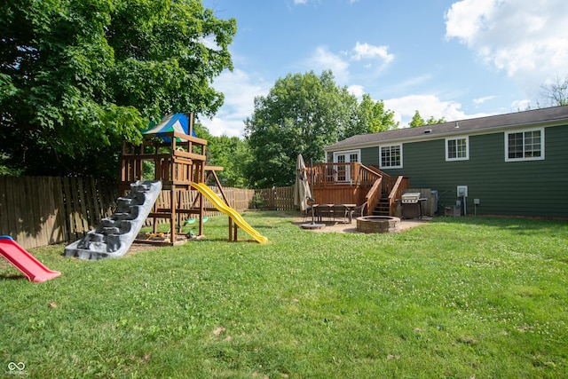 6118 Thrushwood Cir, Indianapolis, IN 46250 - fenced backyard featuring a fire pit, a wooden deck, and a playground