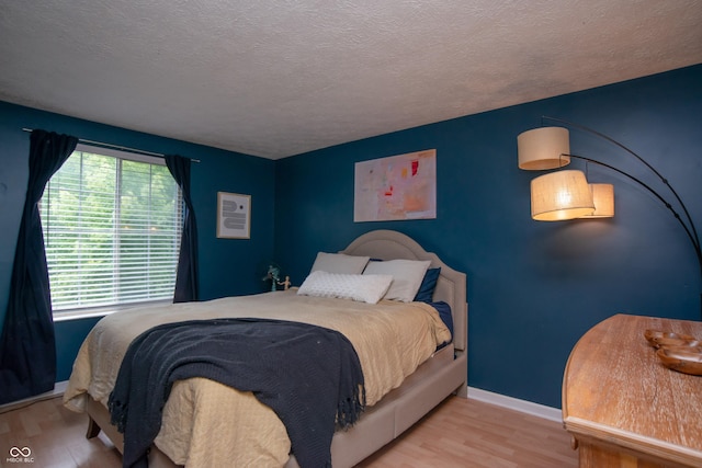 6118 Thrushwood Cir, Indianapolis, IN 46250 - bedroom with wood finished floors and a textured ceiling