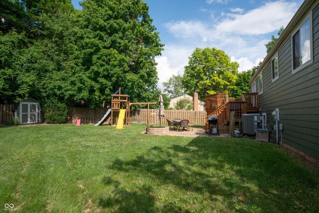 6118 Thrushwood Cir, Indianapolis, IN 46250 - fenced backyard with a shed, a playground, a patio, and a deck