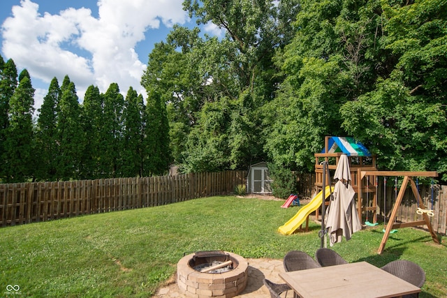 6118 Thrushwood Cir, Indianapolis, IN 46250 - fenced backyard featuring a playground, a fire pit, and a storage unit