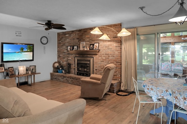 6880 S 850 E, Zionsville, IN 46077 - living room with wood finished floors, a ceiling fan, and a brick fireplace