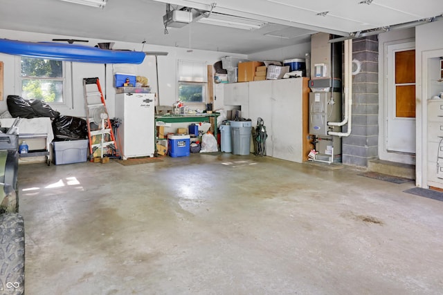6880 S 850 E, Zionsville, IN 46077 - garage featuring a garage door opener and freestanding refrigerator