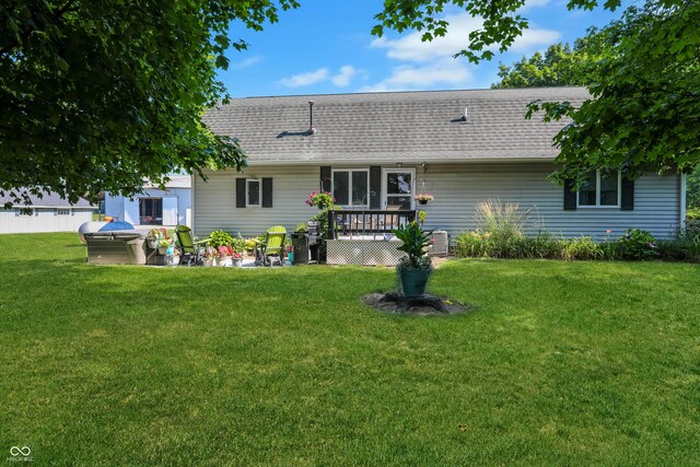 6880 S 850 E, Zionsville, IN 46077 - back of property with a shingled roof, a yard, a hot tub, and a wooden deck