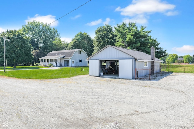 6880 S 850 E, Zionsville, IN 46077 - view of front facade featuring a detached garage, a chimney, an outbuilding, and gravel driveway