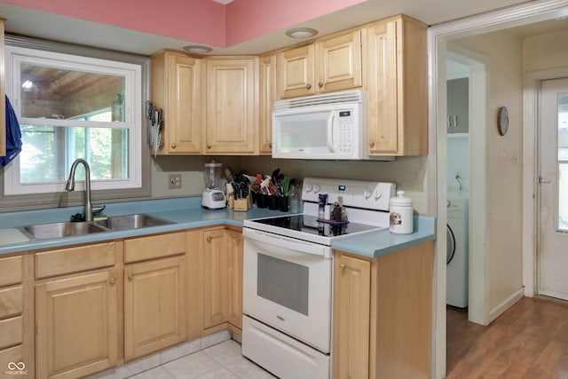 6880 S 850 E, Zionsville, IN 46077 - kitchen with white appliances, light brown cabinetry, washer / clothes dryer, light countertops, and light wood-style flooring