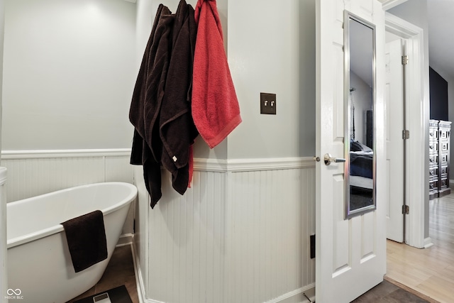 8321 Giroud Way, Indianapolis, IN 46259 - bathroom featuring a freestanding tub and a wainscoted wall