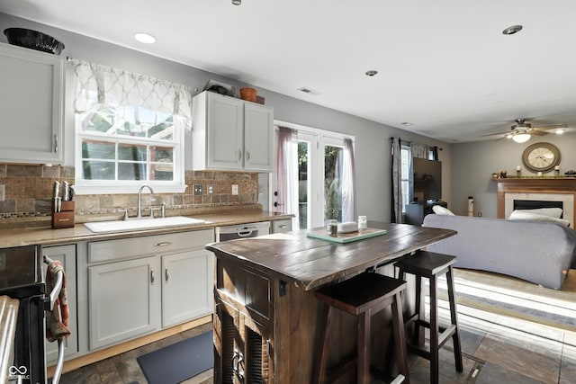 8321 Giroud Way, Indianapolis, IN 46259 - kitchen with decorative backsplash, a ceiling fan, a fireplace, range, and white cabinets