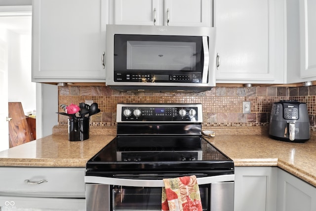 8321 Giroud Way, Indianapolis, IN 46259 - kitchen with stainless steel appliances, backsplash, light countertops, and white cabinetry