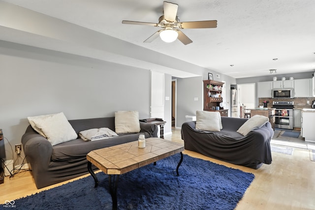 8321 Giroud Way, Indianapolis, IN 46259 - living area featuring light wood-style floors and ceiling fan