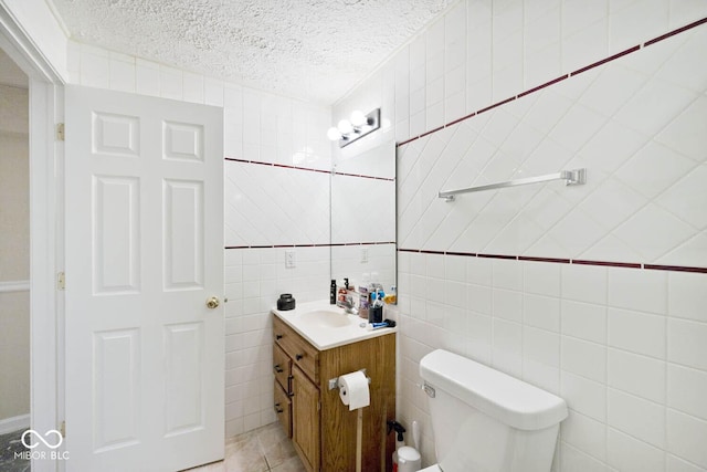 1093 Springwater Dr, Greenwood, IN 46143 - half bathroom with vanity, a textured ceiling, tile walls, and tile patterned floors