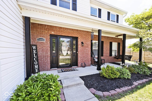 1093 Springwater Dr, Greenwood, IN 46143 - view of exterior entry featuring brick siding and a porch