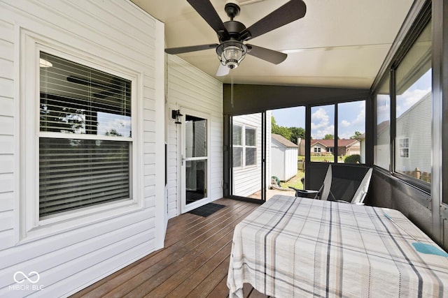 1093 Springwater Dr, Greenwood, IN 46143 - bedroom featuring access to exterior, dark wood-style flooring, lofted ceiling, wooden walls, and ceiling fan