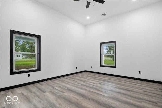 8237 S 100 E, Markleville, IN 46056 - unfurnished room featuring plenty of natural light, a ceiling fan, a high ceiling, wood finished floors, and recessed lighting