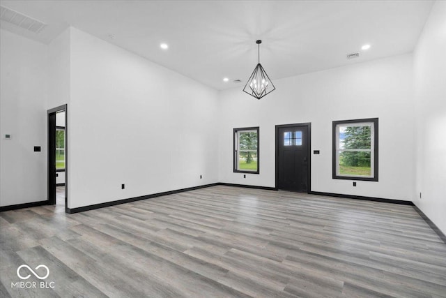 8237 S 100 E, Markleville, IN 46056 - entryway with healthy amount of natural light, a chandelier, a towering ceiling, wood finished floors, and recessed lighting