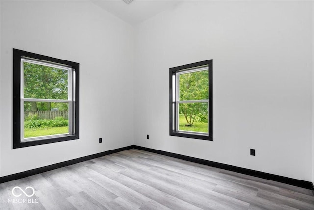 8237 S 100 E, Markleville, IN 46056 - spare room featuring light wood-type flooring and high vaulted ceiling