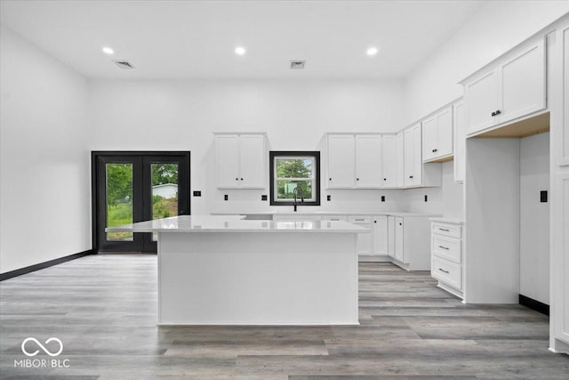 8237 S 100 E, Markleville, IN 46056 - kitchen with a kitchen island, white cabinetry, light countertops, recessed lighting, and light wood-type flooring