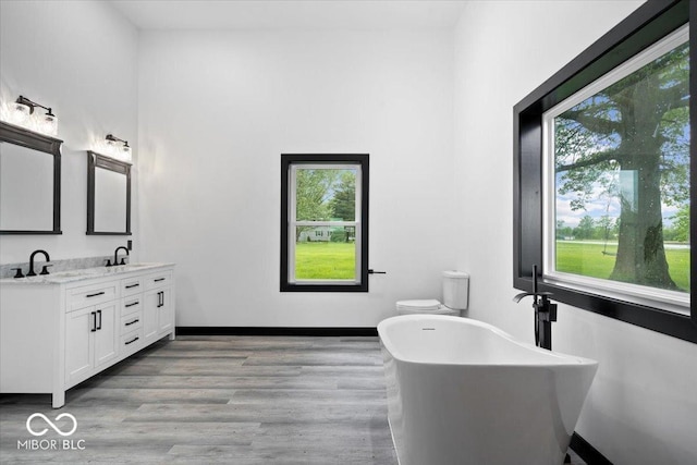 8237 S 100 E, Markleville, IN 46056 - bathroom with double vanity, a soaking tub, and wood finished floors