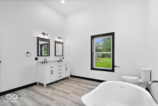 8237 S 100 E, Markleville, IN 46056 - bathroom featuring a freestanding bath, double vanity, wood finished floors, and recessed lighting
