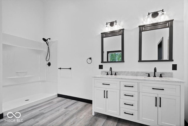 8237 S 100 E, Markleville, IN 46056 - bathroom featuring wood finished floors, double vanity, and a shower