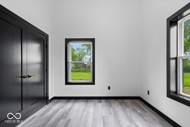 8237 S 100 E, Markleville, IN 46056 - unfurnished bedroom featuring multiple windows and light wood-style floors