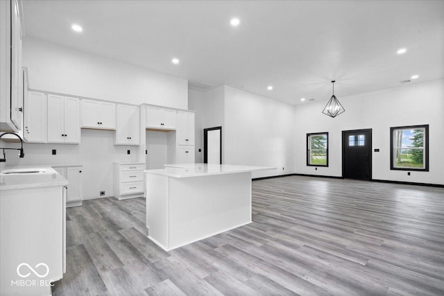 8237 S 100 E, Markleville, IN 46056 - kitchen featuring a center island, recessed lighting, light wood-type flooring, white cabinetry, and open floor plan