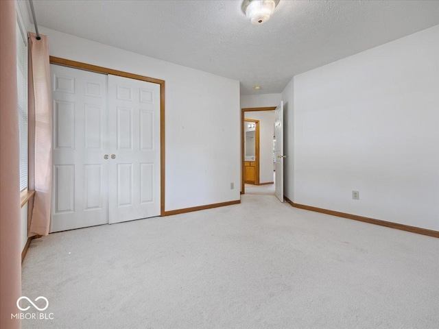 294 Keller Dr, Greenfield, IN 46140 - unfurnished bedroom featuring light carpet, a closet, and a textured ceiling