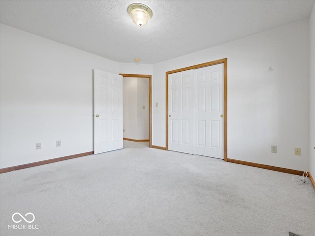 294 Keller Dr, Greenfield, IN 46140 - unfurnished bedroom featuring a closet, carpet, and a textured ceiling
