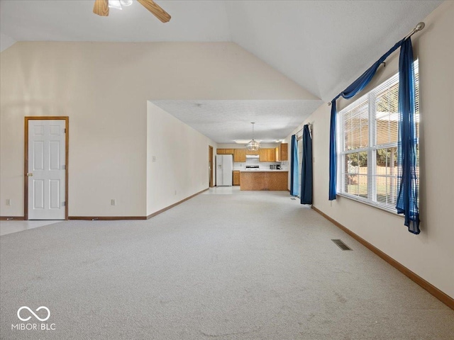 294 Keller Dr, Greenfield, IN 46140 - unfurnished living room with lofted ceiling, light colored carpet, and ceiling fan