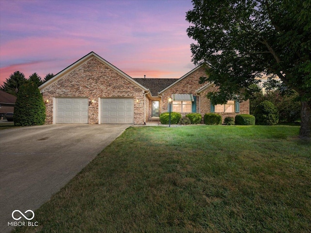 294 Keller Dr, Greenfield, IN 46140 - single story home with concrete driveway, an attached garage, a front lawn, and brick siding