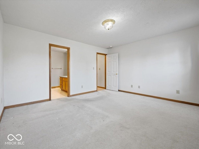 294 Keller Dr, Greenfield, IN 46140 - unfurnished bedroom featuring light carpet, a textured ceiling, and ensuite bathroom