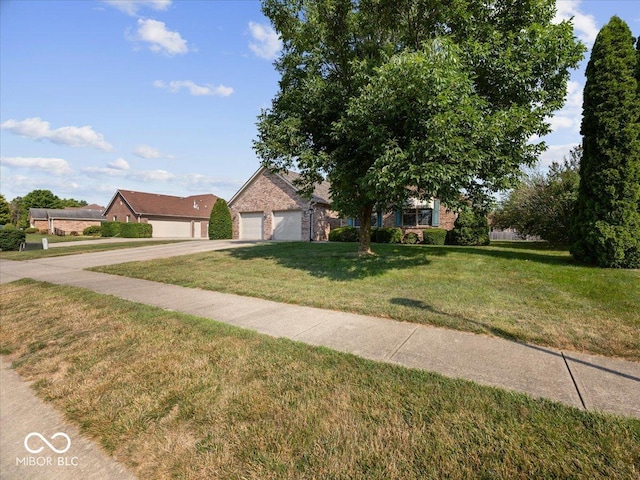 294 Keller Dr, Greenfield, IN 46140 - view of front of house with a front yard, concrete driveway, and a garage