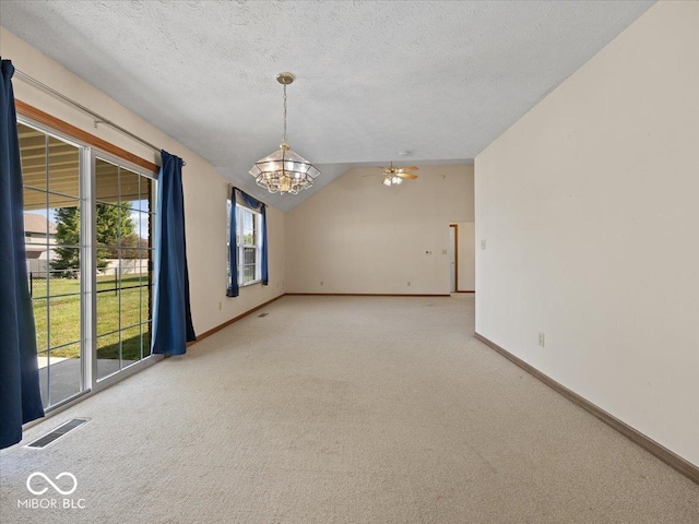 294 Keller Dr, Greenfield, IN 46140 - carpeted empty room with a chandelier, vaulted ceiling, and a textured ceiling