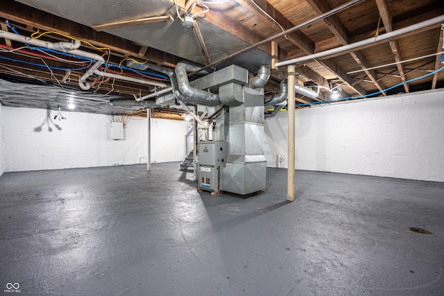 726 N Routiers Ave, Indianapolis, IN 46219 - unfinished basement featuring heating unit, concrete block wall, and stairs