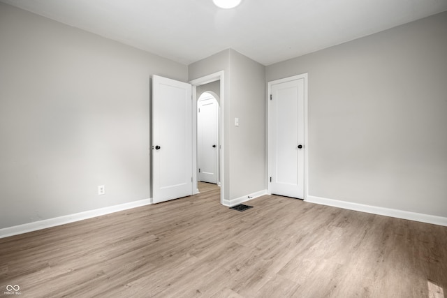 726 N Routiers Ave, Indianapolis, IN 46219 - unfurnished bedroom with light wood-style floors and baseboards