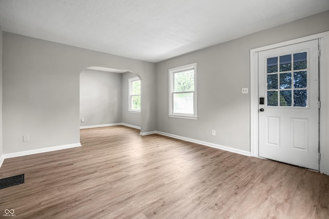 726 N Routiers Ave, Indianapolis, IN 46219 - foyer entrance with arched walkways and wood finished floors