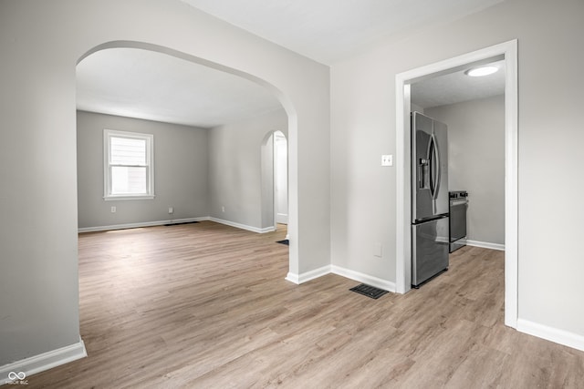726 N Routiers Ave, Indianapolis, IN 46219 - spare room with arched walkways and light wood-style flooring