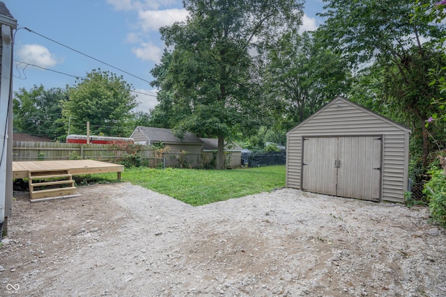 726 N Routiers Ave, Indianapolis, IN 46219 - fenced backyard with a storage unit and a deck